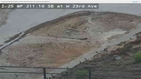 Rain washes mud and debris onto flooded I-25